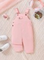 Jasnoróżowy kombinezon kieszenie (9-12M)