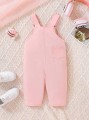 Jasnoróżowy kombinezon kieszenie (9-12M)