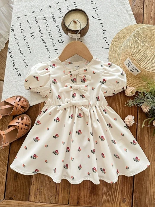 Sukienka ecru wzór kokardy (6-9M)